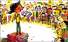 Girl standing on stack of books reading aloud to a crowd of children 